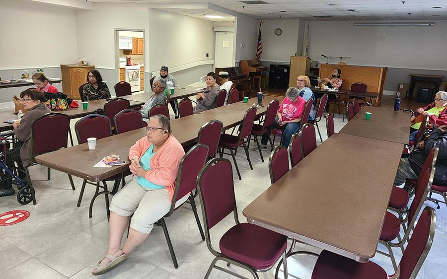 group of residents seated at long tables