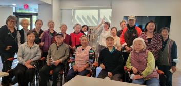 group of elderly people posing in a room