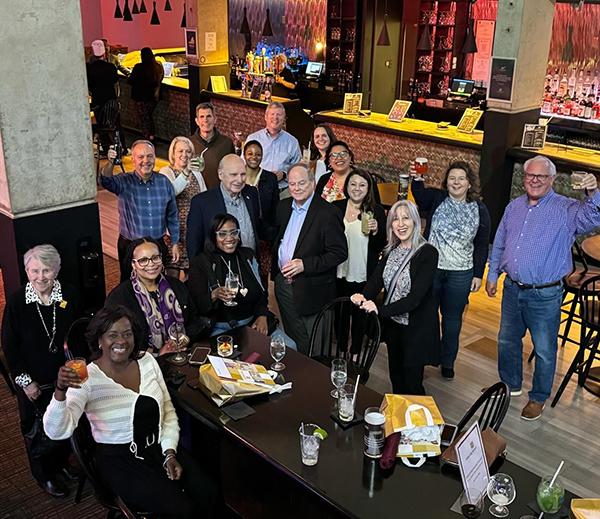 group of adults posing in a bar