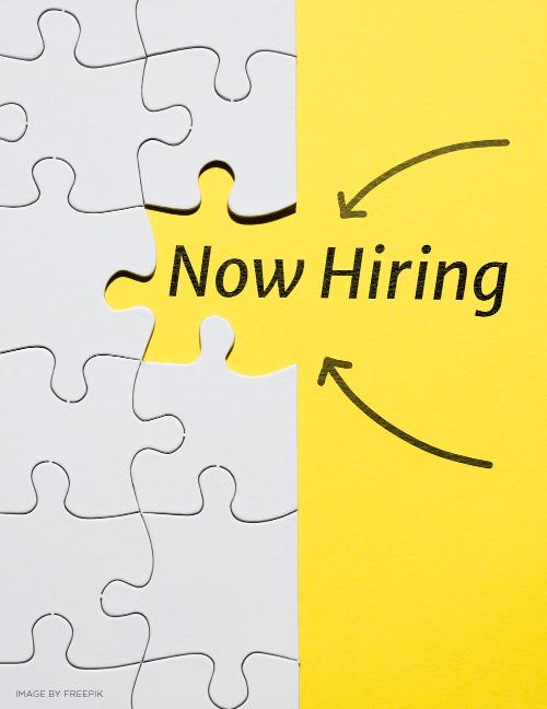 white puzzle pieces with one missing and arrows pointing to missing piece with words now hiring