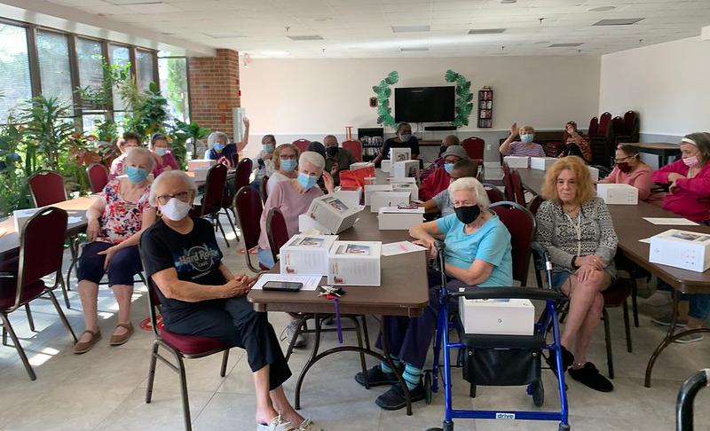 group of residents seated at long tables