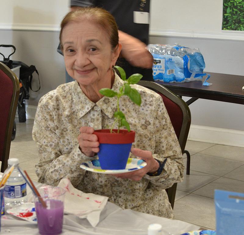 woman holding a potted plant