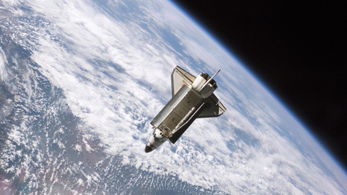 space vehicle in space with Earth and sky in the background