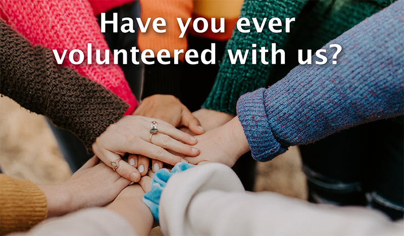8 hands clasped in a circle with message have you ever volunteered with us