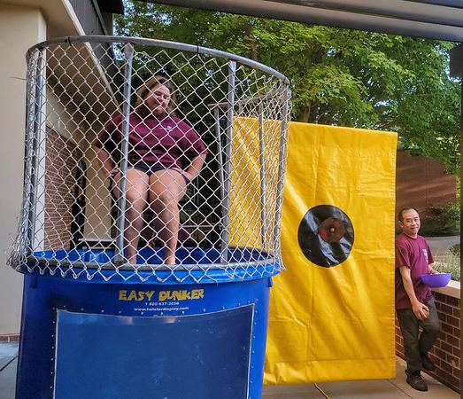 Christy sitting in the cage of a dunk tank game