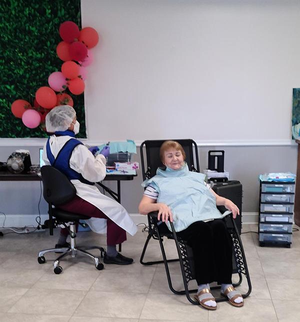 dentist and patient with balloons in background