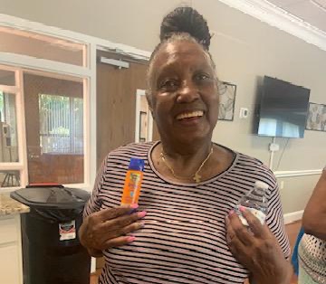 woman holds up bottles of sunscreen