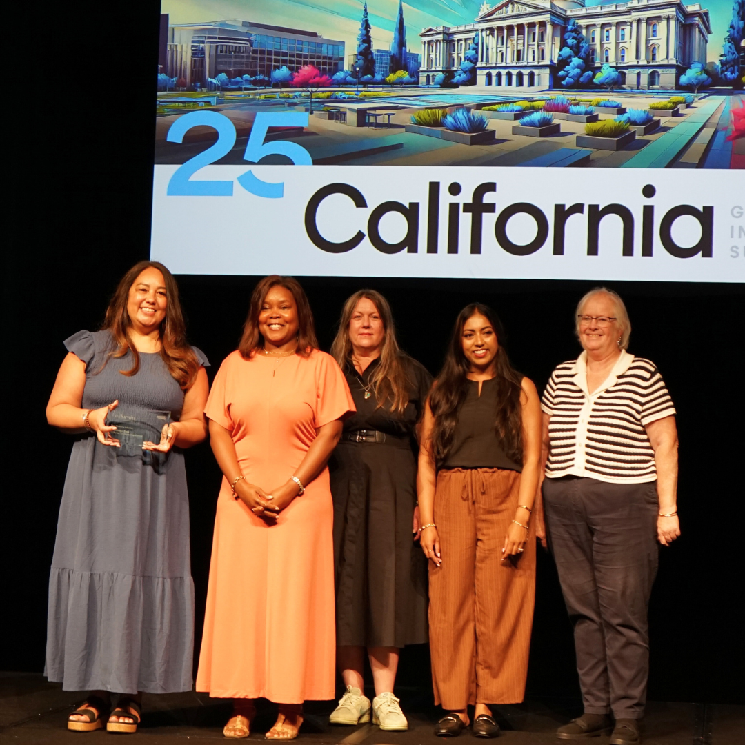 Staff from the California Civil Rights Department stand on the stage to accept an award for best workforce initiative.  