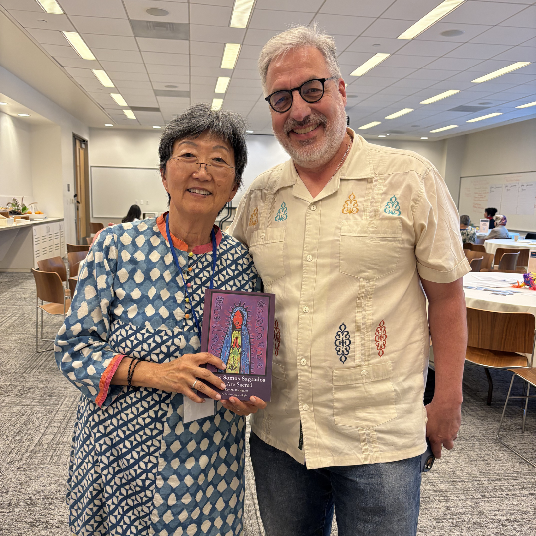 Angela from CRD's Community Conflict Resolution Unit smiles with a Peacemaker's Gathering attendee.