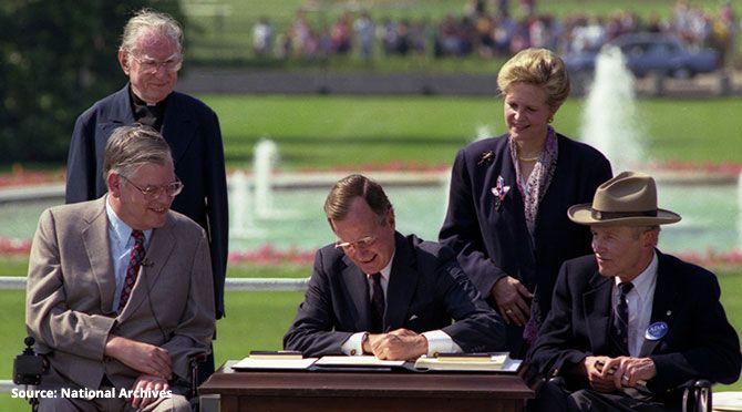 President George H.W. Bush signing the Americans with Disabilities Act on July 26 1990.