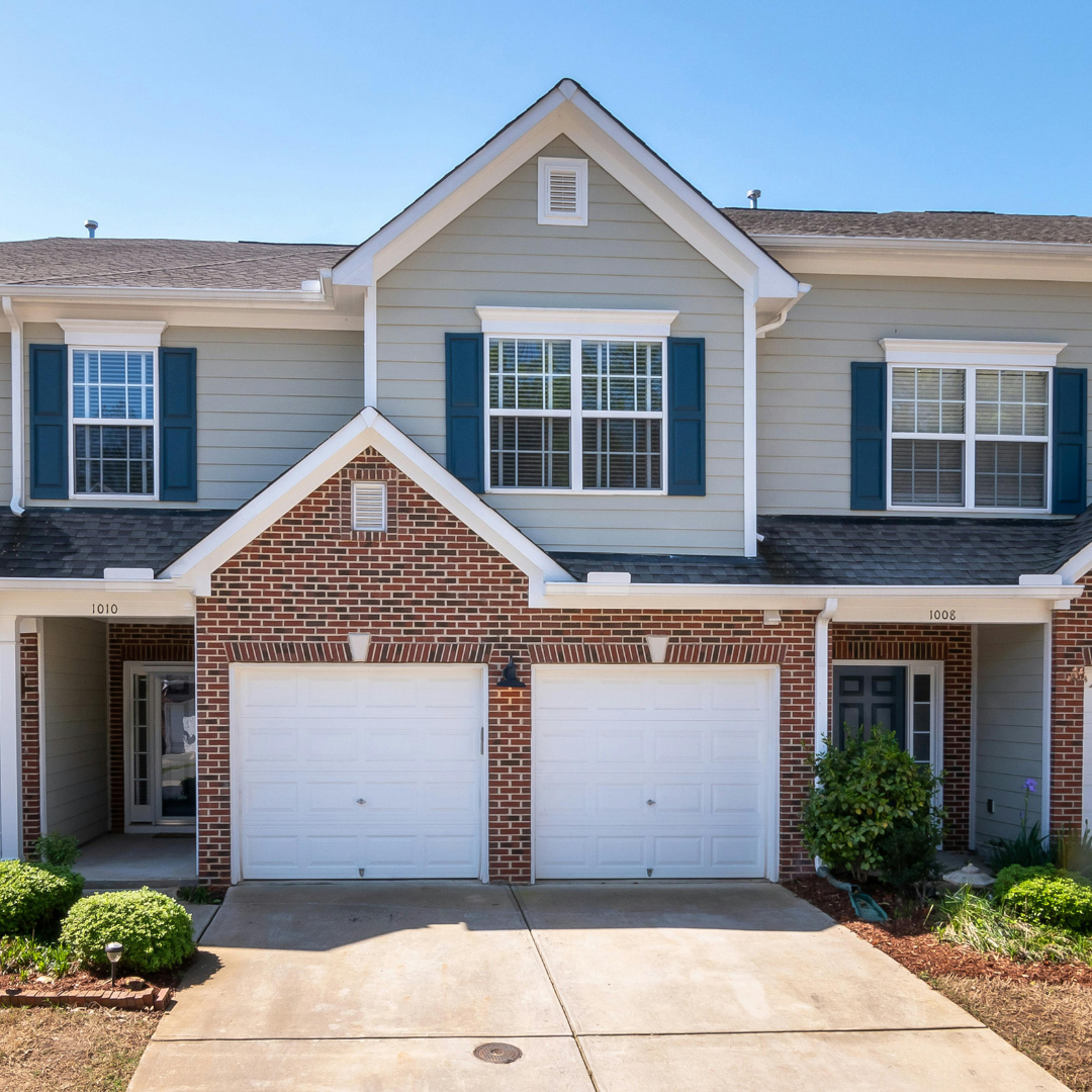 A duplex with brick and wood siding.