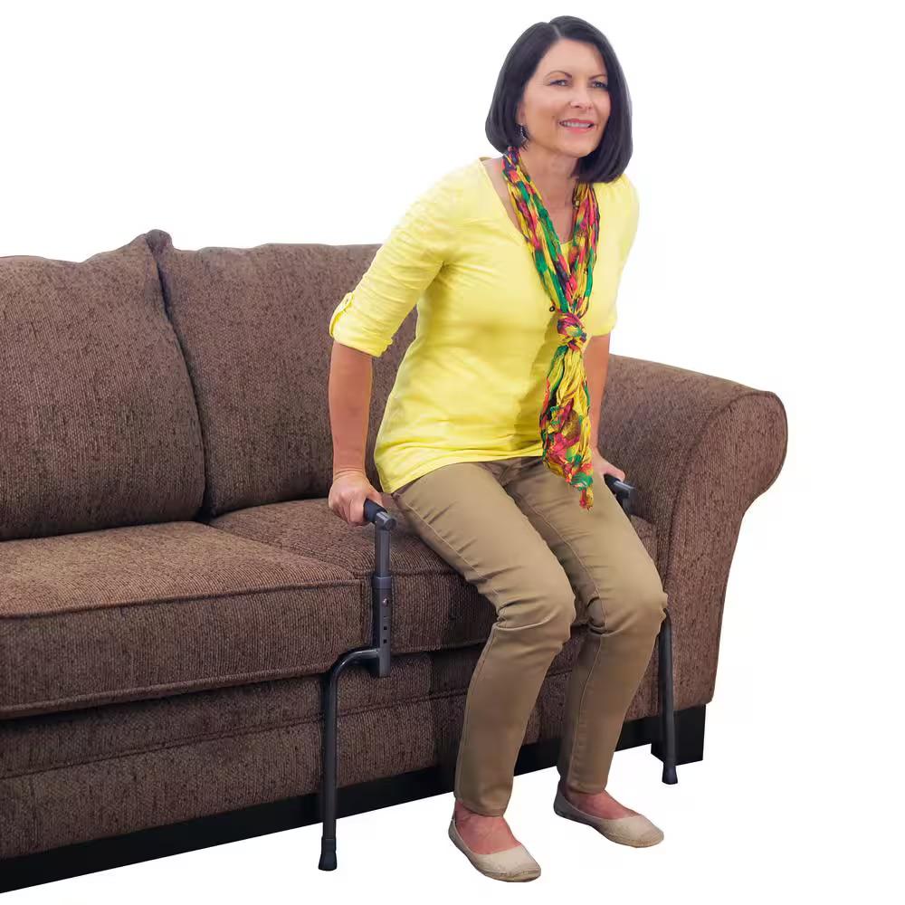 woman using stand assist to get up from couch