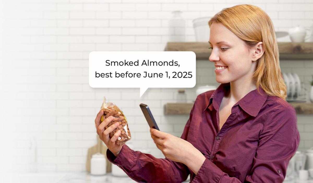 woman scanning a tag on nuts and phone is telling her she is holding sliced almonds