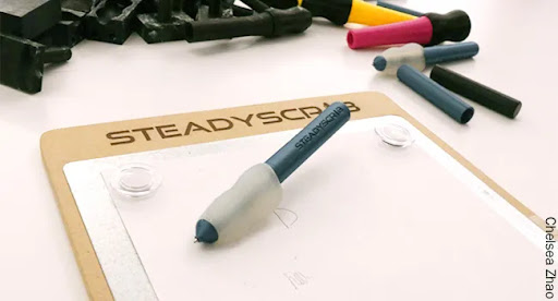 SteadyScribe shown with pen on paper connected to the magnetic board