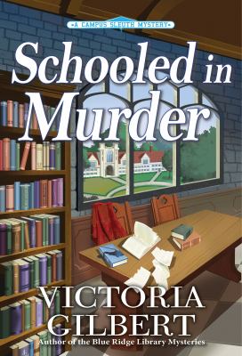 Book cover for Schooled in Murder by Victoria Gilbert. The illustration shows the inside of a study or library with bookshelves a large wooden desk cluttered with scattered papers an open book and a red satchel. Through a tall arched window in the background a green campus landscape with buildings is visible under a blue sky. The title appears in large white letters across the top with the author name at the bottom.