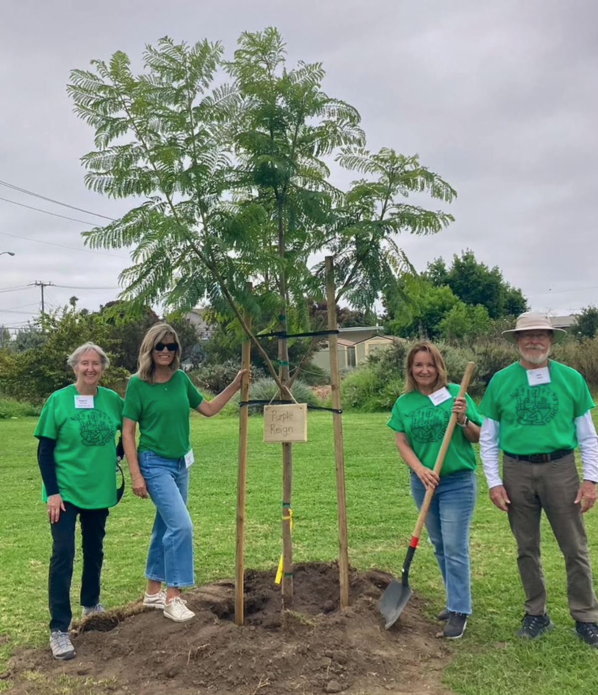 Members of the Ventura Tree Alliance pose in front of new trees they've just planted at a school called Will Rogers