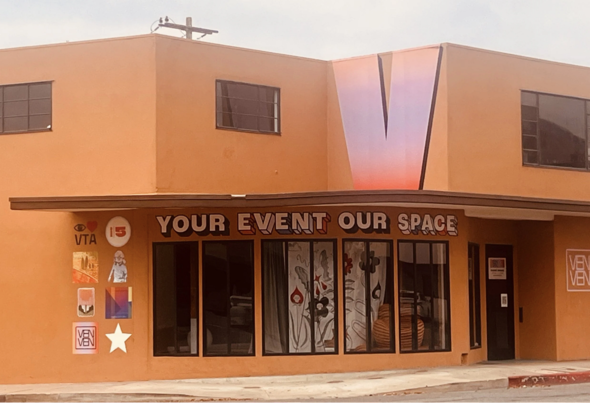 Image of a building that says Your Event Our Space and a large V in front
