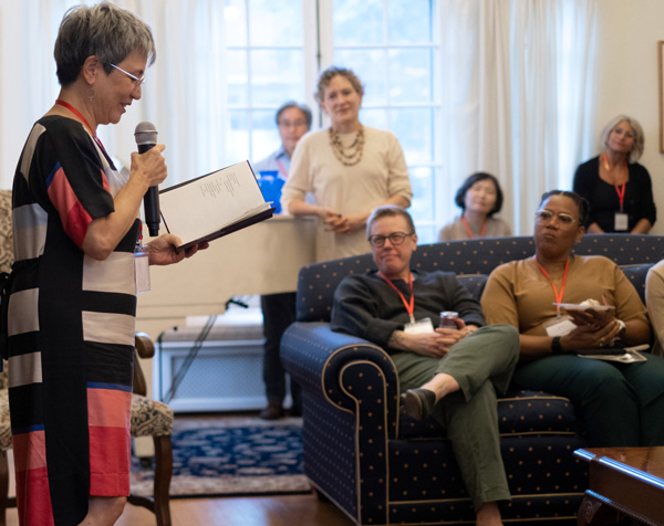 Kimiko Hahn with microphone reading poems