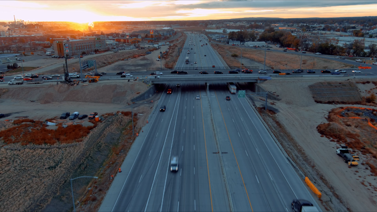 Aerial view of I-84 at sunrise with light traffic and the Karcher Interchange Bridge crossing it. 