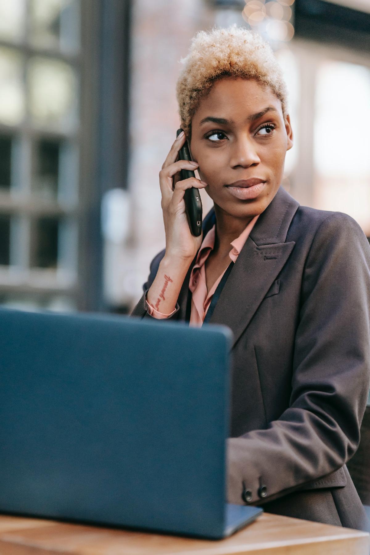 woman at work with laptop and phone