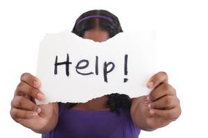 Child hold a HELP sign