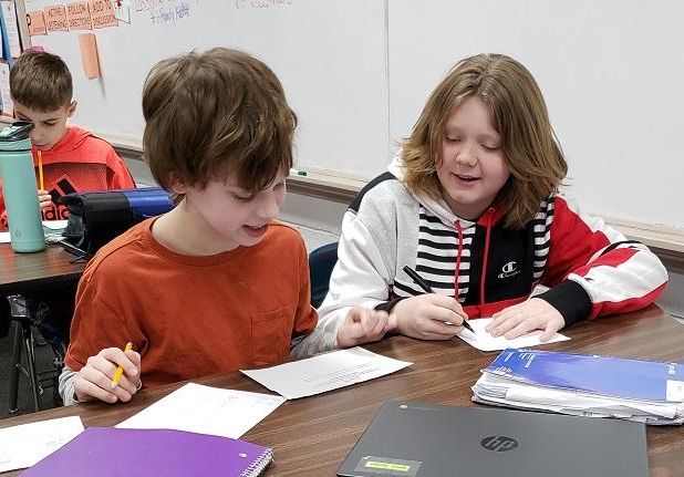 Two students working together on an assignment