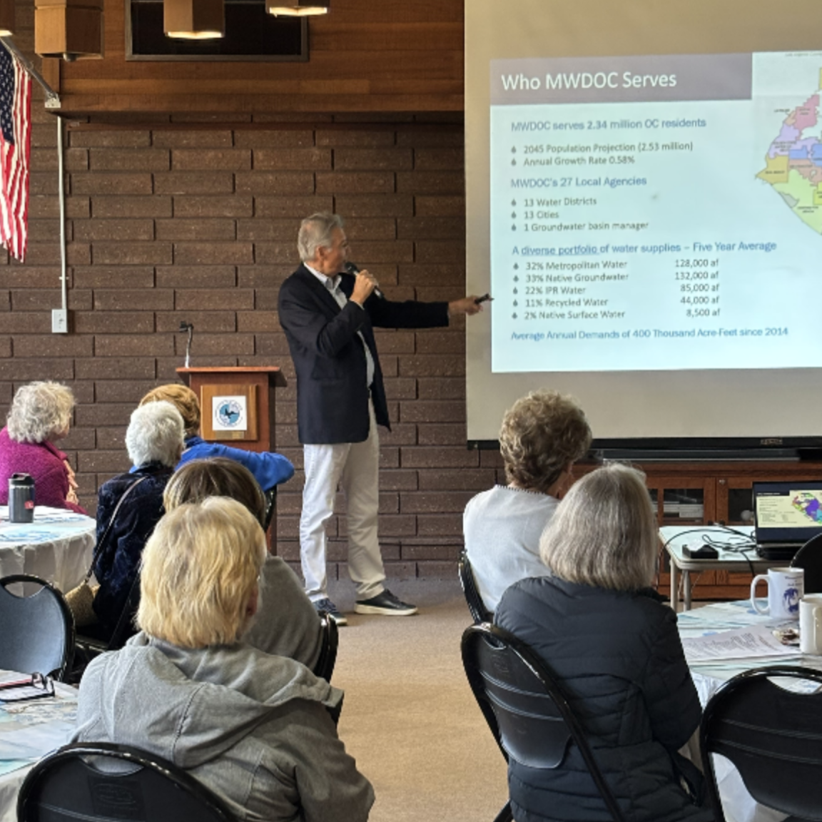 Director Karl Seckel speaking at an event