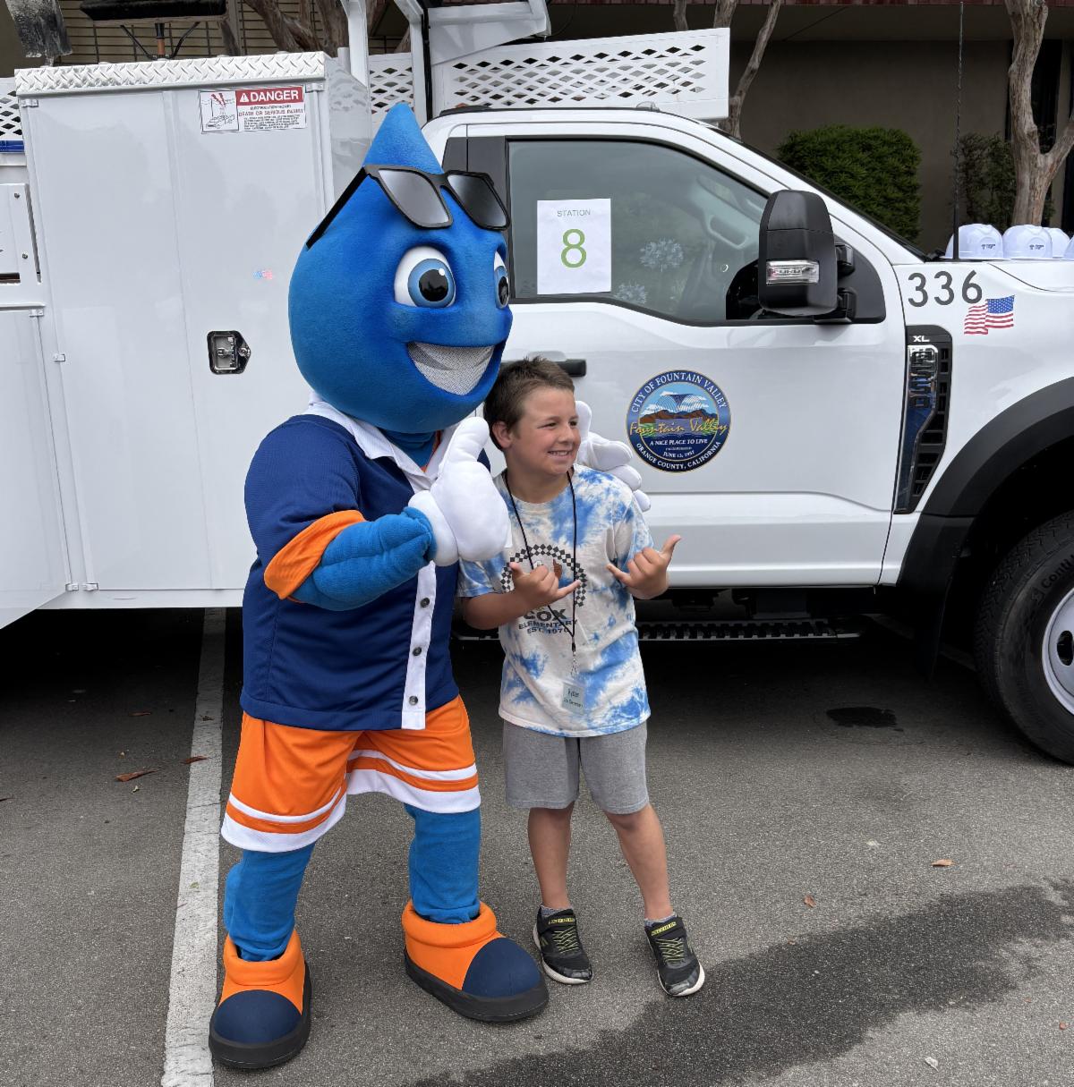 Mascot Ricky Raindrop with student
