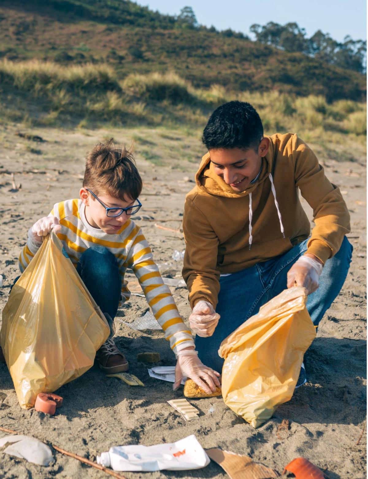picking up trash on a beach