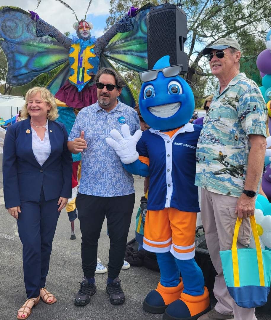 Ricky raindrop posing with Director Erdman and friends at SMWD event