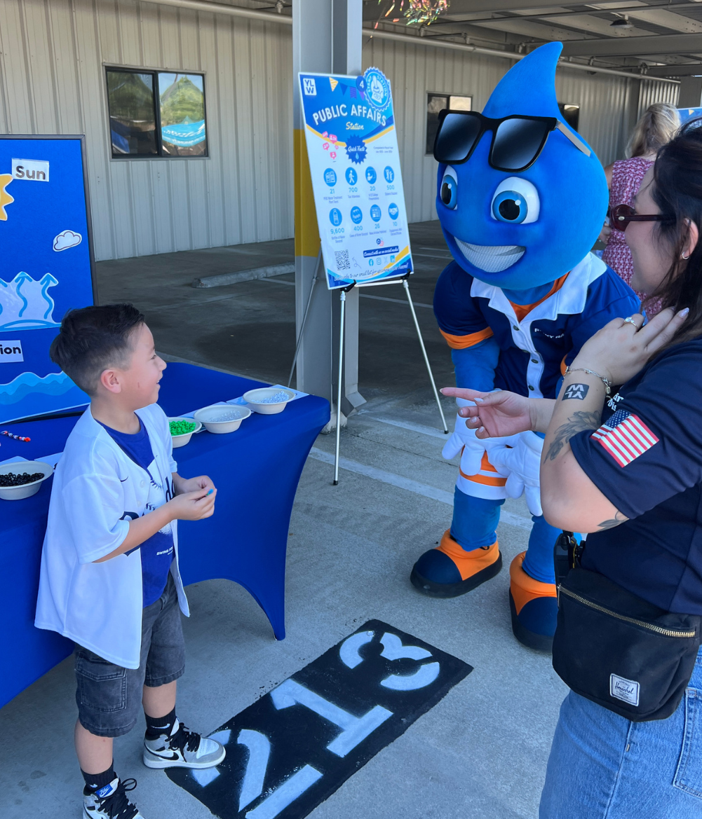 Ricky raindrop with a child at YLWD open house