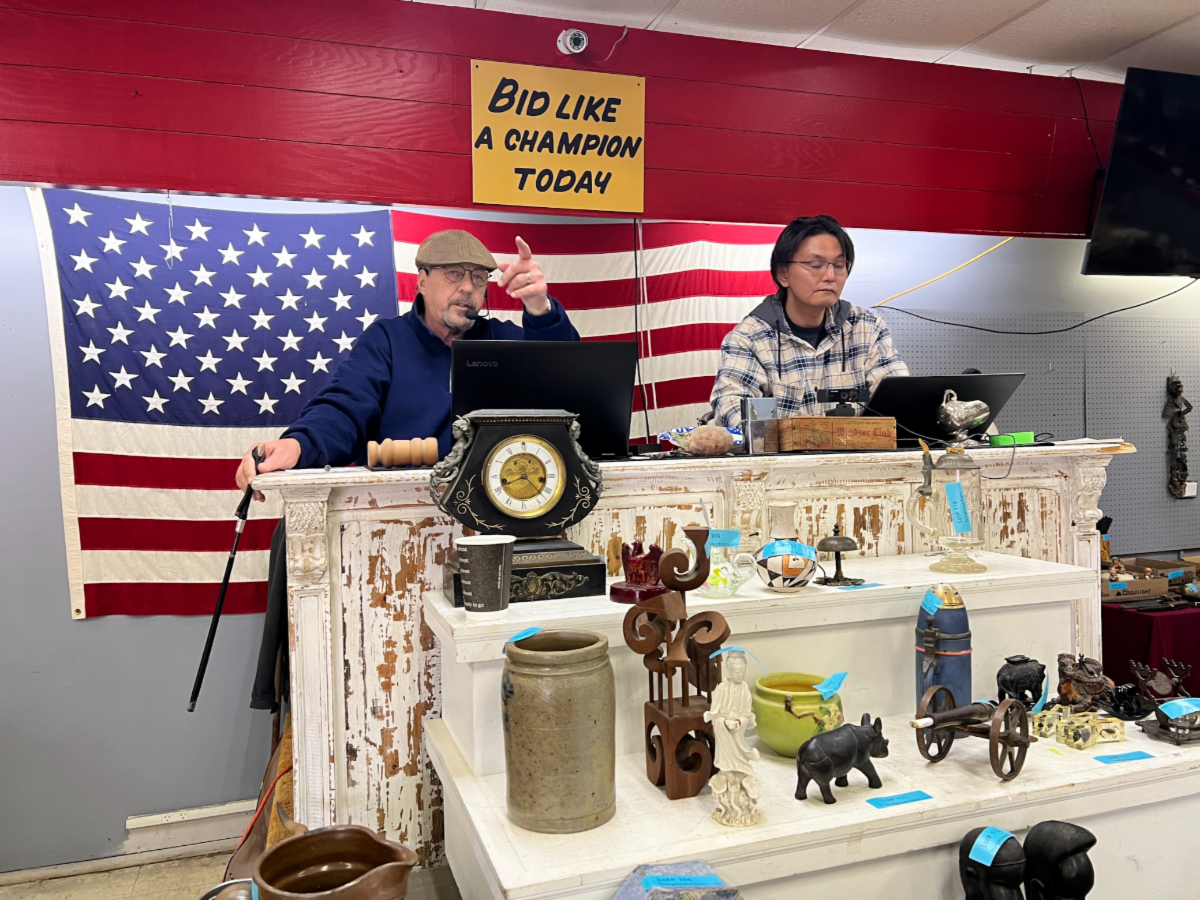 Auction block and podium at Burgess Auctions LLC Knightstown Indiana facility with American flag
