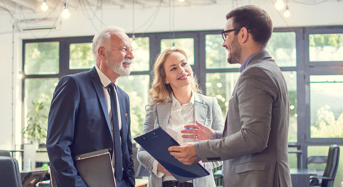 Three colleagues discussing business