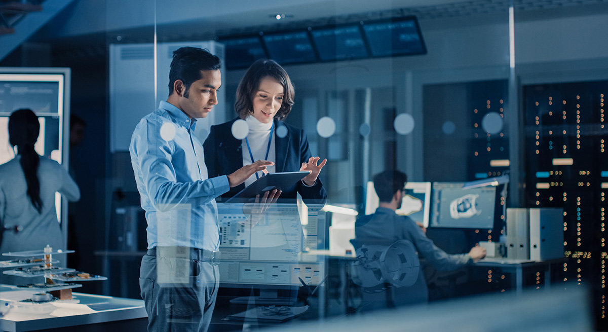 Two colleagues working together on a tablet