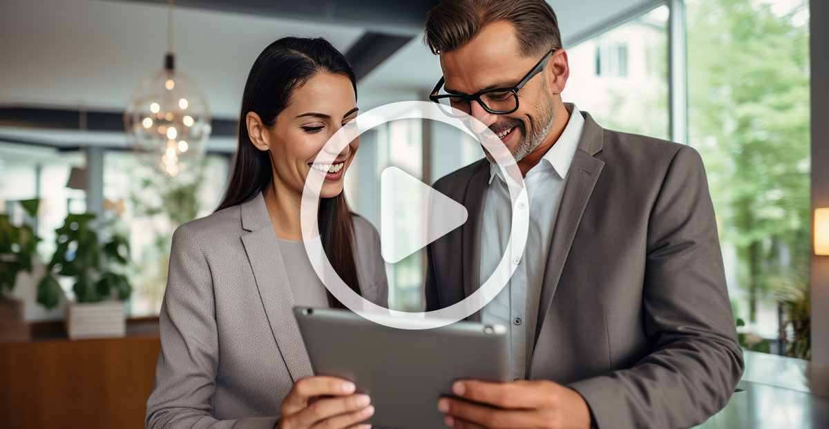 Business Man Looking At Tablet With Business Woman