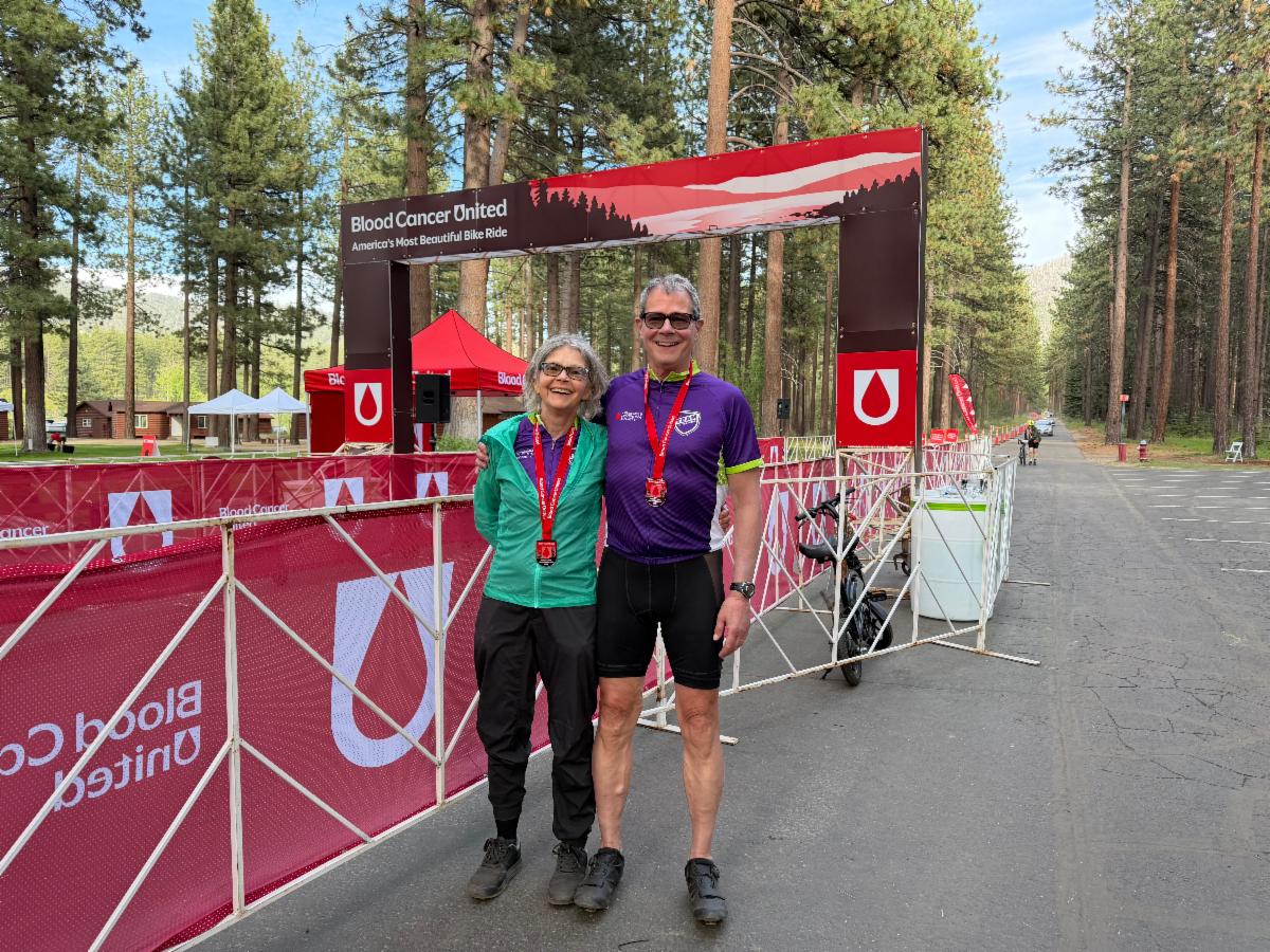 Suzie and her brother after their big bike ride, smiling with medals!