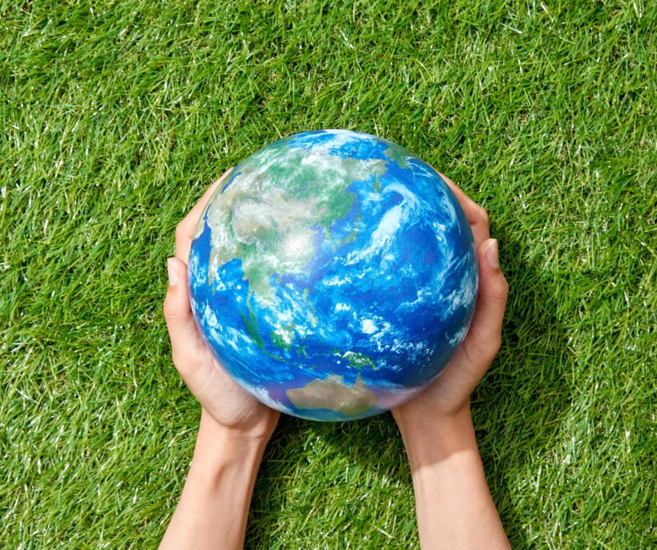 Image of hands holding a replica of the Earth