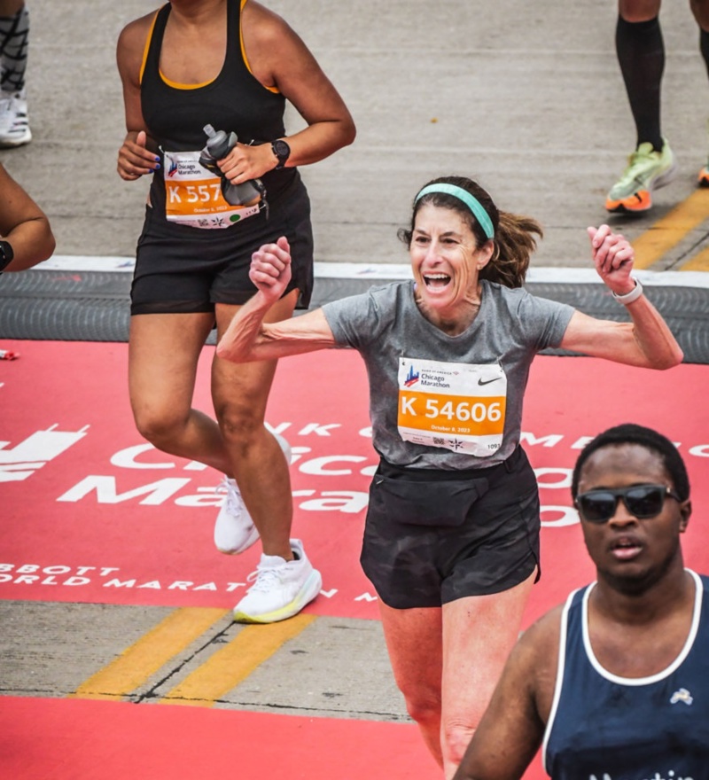 cathy zimmerman crossing finish line at chicago marathon