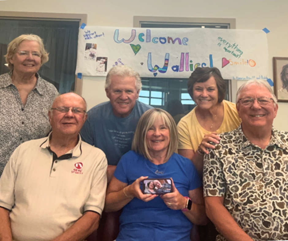 Group shot of Heartland Support Group with "Welcome Wallies" banner