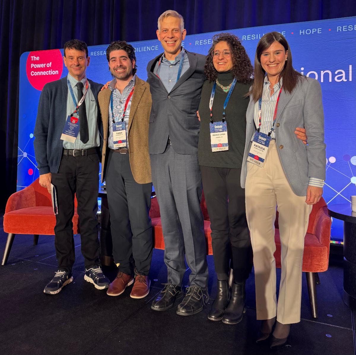Group of physician scientists standing on stage at Ed Forum: The Next Frontier in WM Panel including Drs. Steven Treon-Moderator, Tarek Mouhieddine, Zachary Hunter, Maria Guerrero, Patrizia Mondello