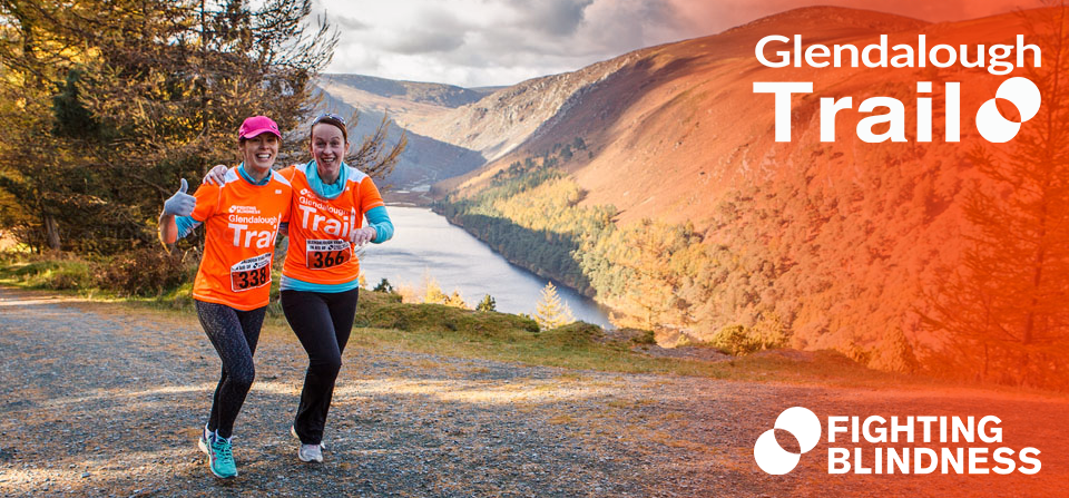 An image of two people running on the Glendalough Trail. They are wearing orange Fighting Blindness t-shirts.