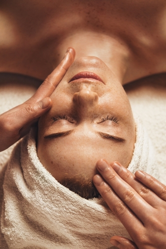 Close-up of young woman getting spa massage treatment at beauty spa salon. Spa beauty treatment concept. Body skin care