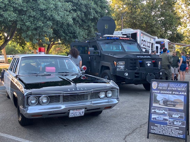 Display featuring a 1968 Dodge Polara and a larger, more equipped police vehicle