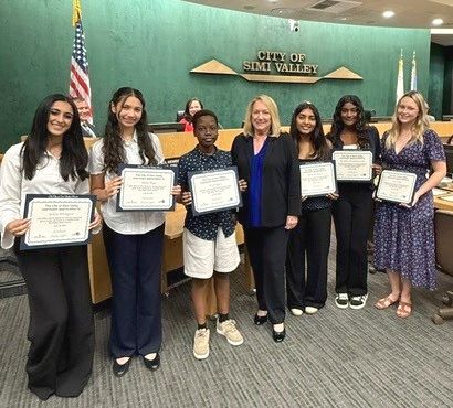 Outgoing Youth Council members standing with Mayor Cavanaugh and holding their certificates of appreciation