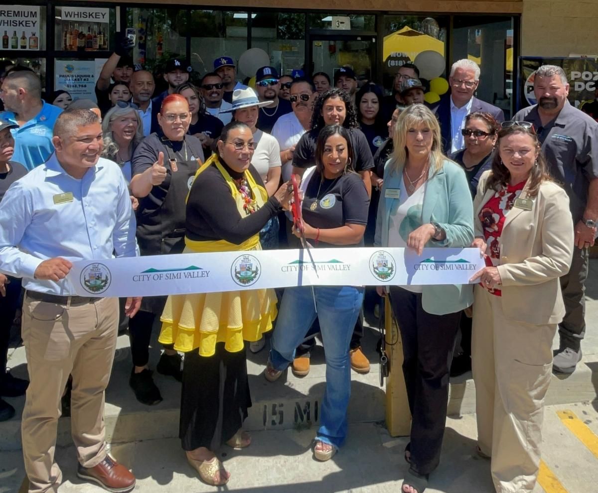 Large group of people at a ribbon cutting event for Pozoleria Doña Ana
