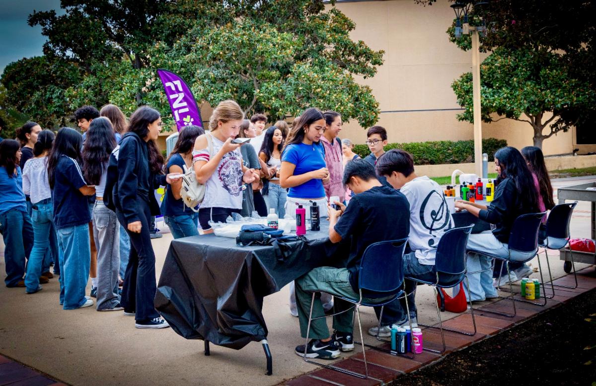 People at the rock painting night event in line to pick out rocks