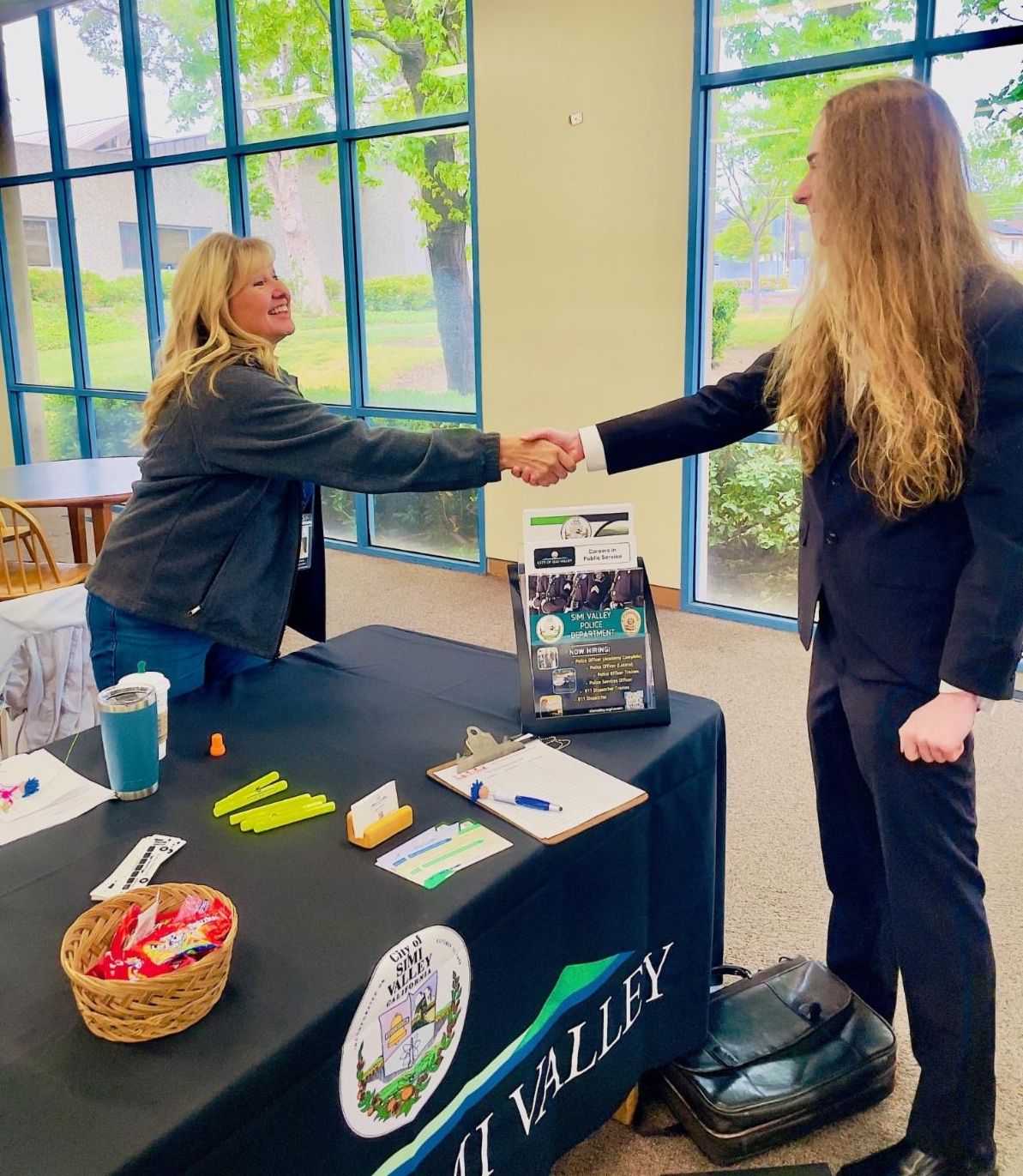 Employer shaking hands with a job seeker at a job fair