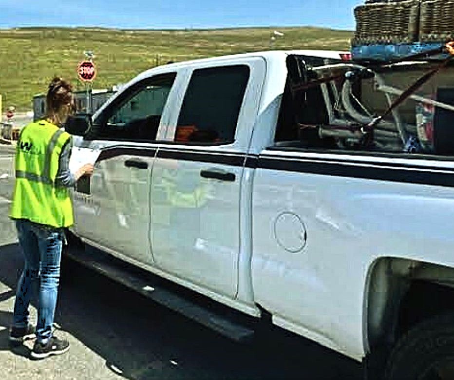 WM employee speaking with resident in truck at a former Free Landfill Day event