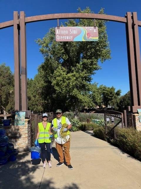 Two Coastal Cleanup Day volunteers standing on a trail.