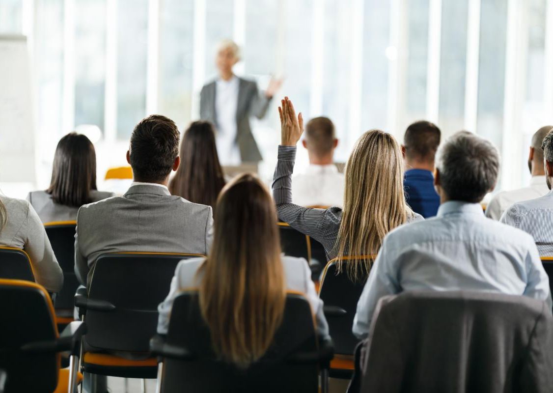 large group sitting facing a workshop leader